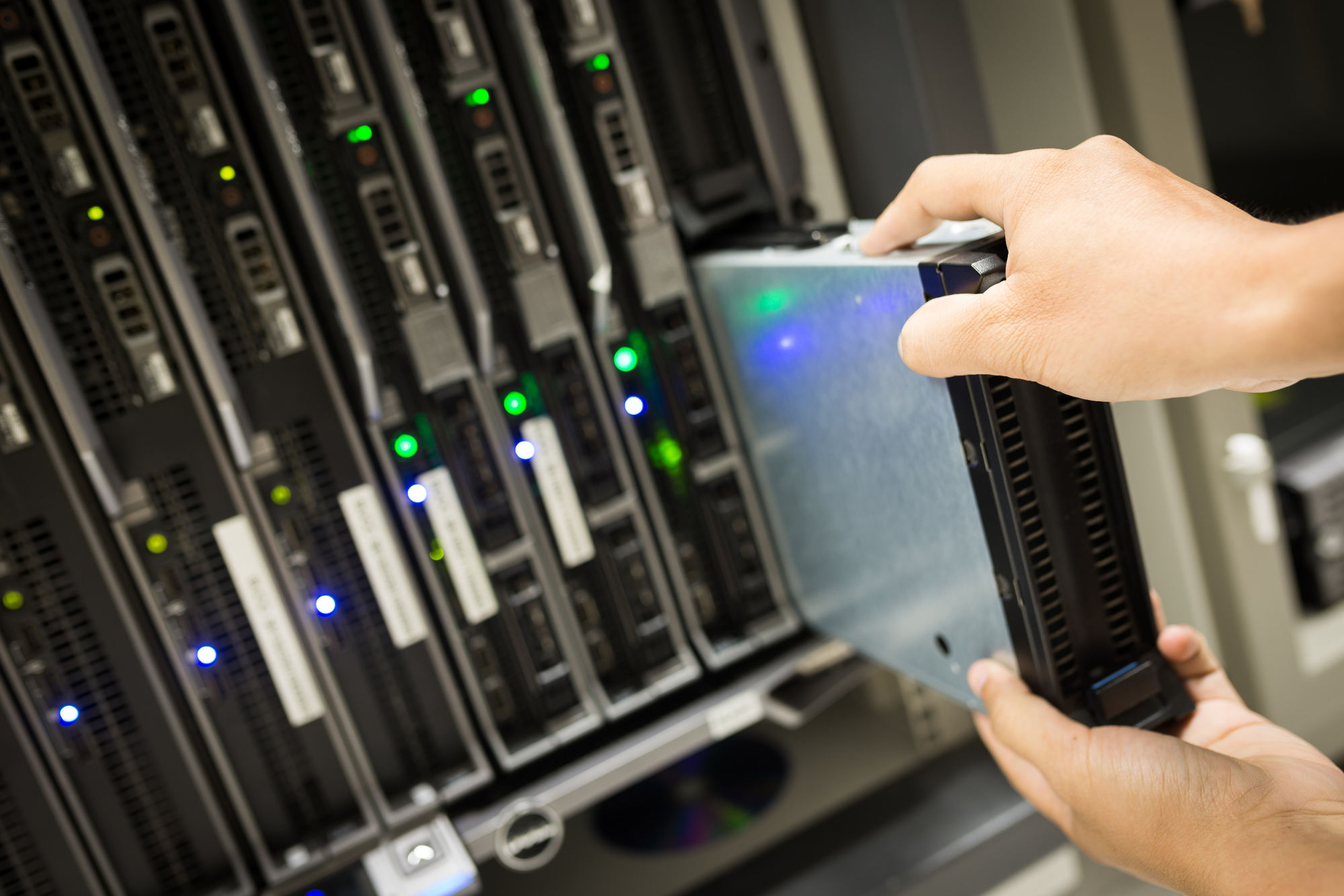 A person holds a small server in their hand, showcasing the device's compact size and technology.